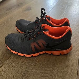 Grey and neon orange nike shoes